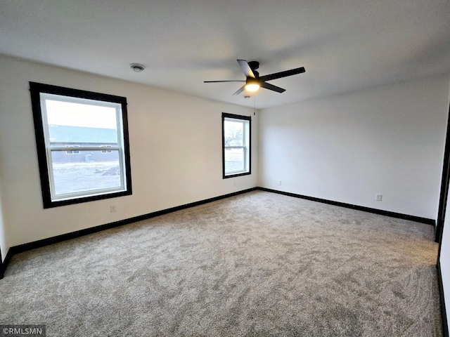 1109 9th Ave SE, Waseca, MN 56093 - spare room featuring carpet, ceiling fan, and baseboards