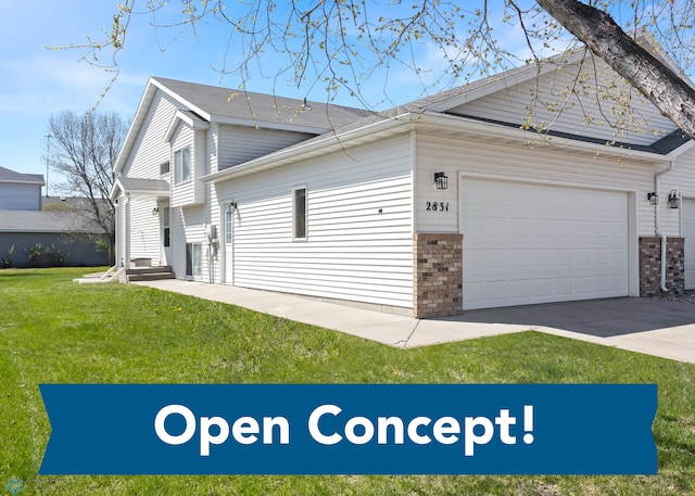 2831 Wheatland Dr S, Fargo, ND 58103 - view of side of property with brick siding, a yard, a garage, and driveway