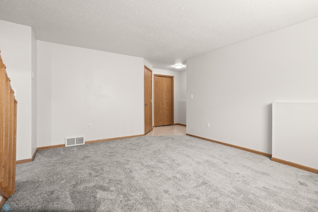 2831 Wheatland Dr S, Fargo, ND 58103 - empty room with carpet floors, baseboards, and a textured ceiling