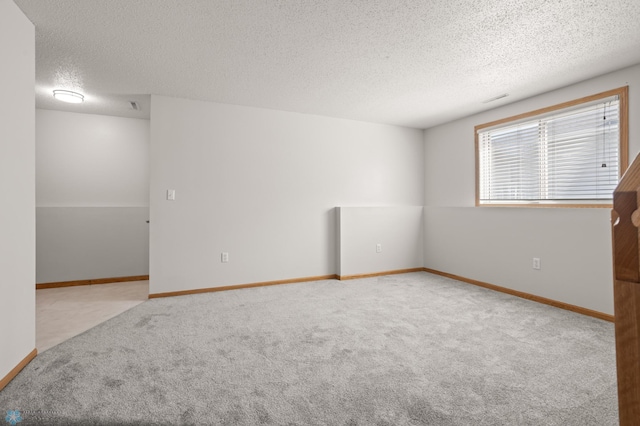 2831 Wheatland Dr S, Fargo, ND 58103 - spare room with a textured ceiling, carpet, and baseboards