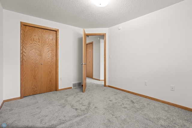2831 Wheatland Dr S, Fargo, ND 58103 - unfurnished bedroom with carpet, a textured ceiling, and baseboards