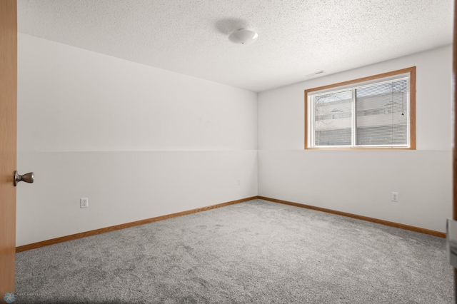 2831 Wheatland Dr S, Fargo, ND 58103 - unfurnished room featuring carpet flooring, a textured ceiling, and baseboards