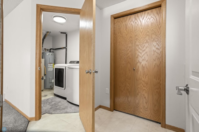 2831 Wheatland Dr S, Fargo, ND 58103 - hallway featuring electric water heater, baseboards, washer and dryer, and light floors