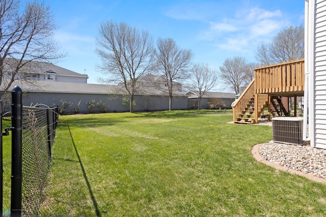 2831 Wheatland Dr S, Fargo, ND 58103 - view of yard featuring central AC, stairs, and a wooden deck