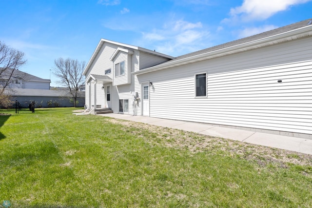 2831 Wheatland Dr S, Fargo, ND 58103 - rear view of property with a yard and entry steps