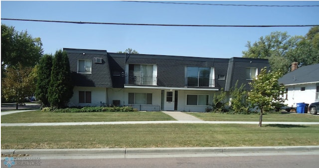702 Oak St N Unit C, Fargo, ND 58102 - view of front of property with mansard roof, a front yard, and a balcony