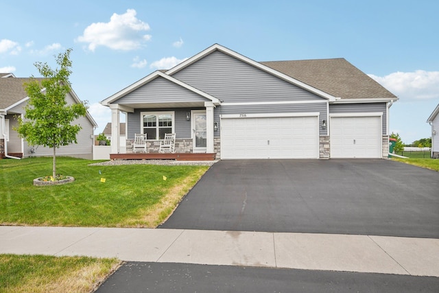 7516 Ochoa Ave NE, Otsego, MN 55330 - view of front of house with asphalt driveway, an attached garage, covered porch, a front lawn, and stone siding