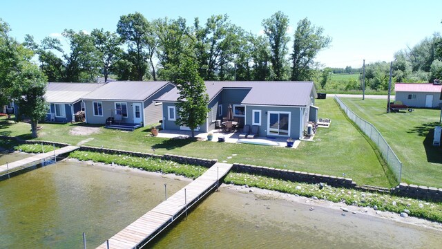 27096 Little Floyd Lake Rd Unit 1, Detroit Lakes, MN 56501 - rear view of property with a patio, metal roof, a water view, and a yard