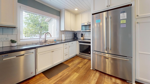 27096 Little Floyd Lake Rd Unit 1, Detroit Lakes, MN 56501 - kitchen featuring appliances with stainless steel finishes, a sink, light wood-style floors, dark countertops, and recessed lighting