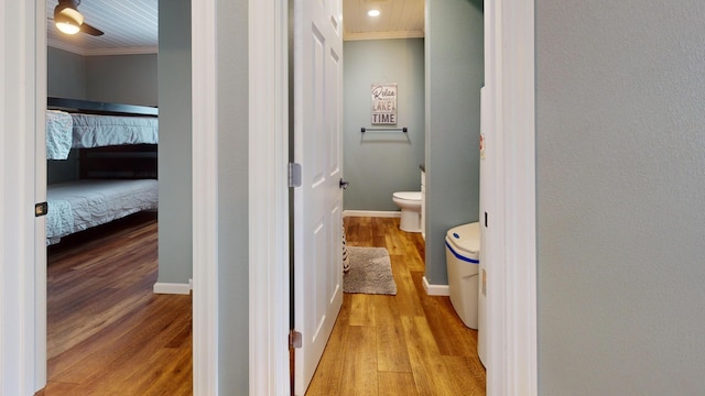27096 Little Floyd Lake Rd Unit 1, Detroit Lakes, MN 56501 - bathroom with ornamental molding, toilet, wood finished floors, connected bathroom, and baseboards