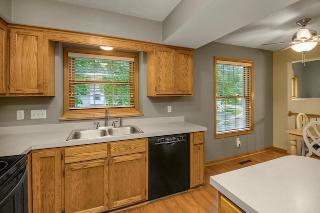 4906 Bayswater Rd, Minnetonka, MN 55345 - kitchen with black appliances, a sink, light wood finished floors, light countertops, and a ceiling fan