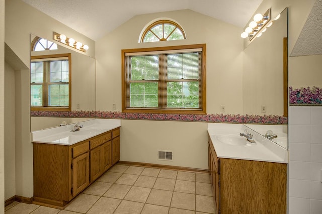 4906 Bayswater Rd, Minnetonka, MN 55345 - bathroom featuring two vanities, lofted ceiling, and tile patterned flooring