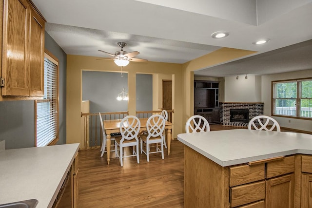 4906 Bayswater Rd, Minnetonka, MN 55345 - kitchen with a brick fireplace, light countertops, wood finished floors, ceiling fan, and open floor plan