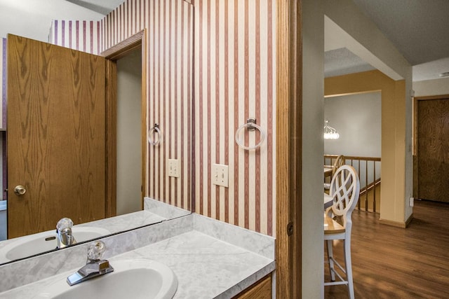 4906 Bayswater Rd, Minnetonka, MN 55345 - bathroom featuring wallpapered walls, wood finished floors, and vanity