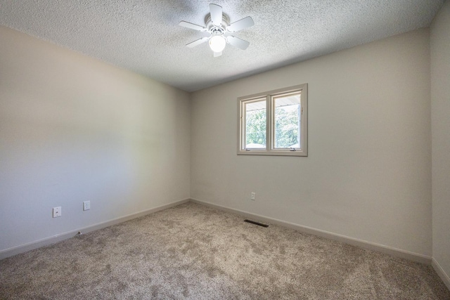 1605 4th St SW, Austin, MN 55912 - empty room with carpet floors, a ceiling fan, baseboards, and a textured ceiling