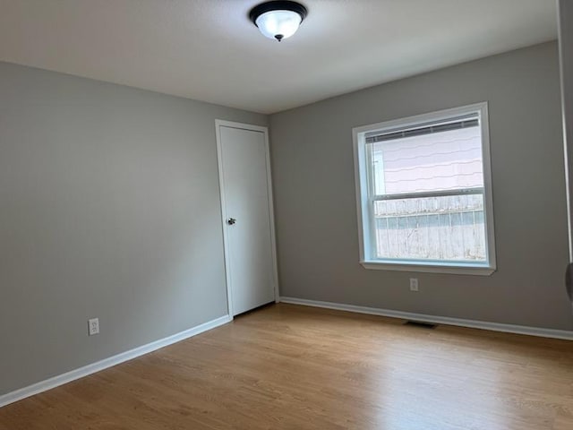 98 Magnolia Ave W, Saint Paul, MN 55117 - unfurnished room featuring wood finished floors and baseboards