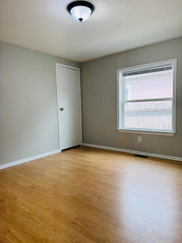 98 Magnolia Ave W, Saint Paul, MN 55117 - unfurnished room with light wood-type flooring and baseboards