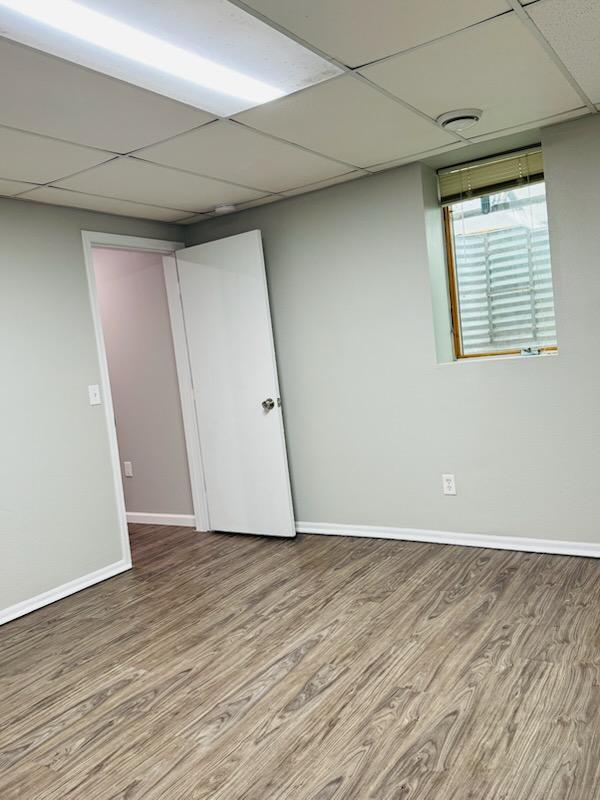 98 Magnolia Ave W, Saint Paul, MN 55117 - below grade area with wood finished floors, baseboards, and a paneled ceiling