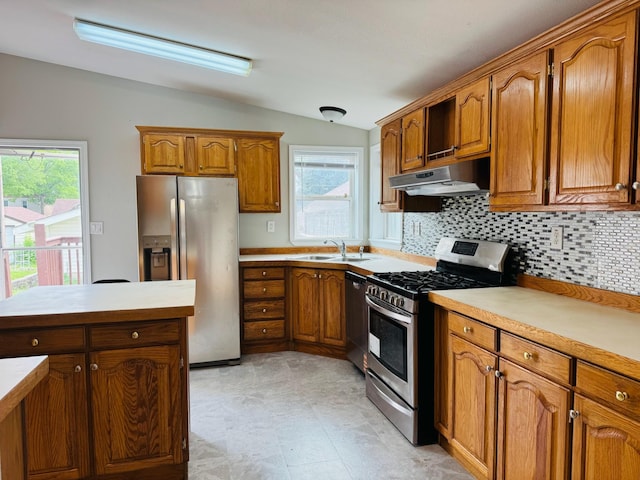 98 Magnolia Ave W, Saint Paul, MN 55117 - kitchen with stainless steel appliances, a sink, vaulted ceiling, under cabinet range hood, and brown cabinetry