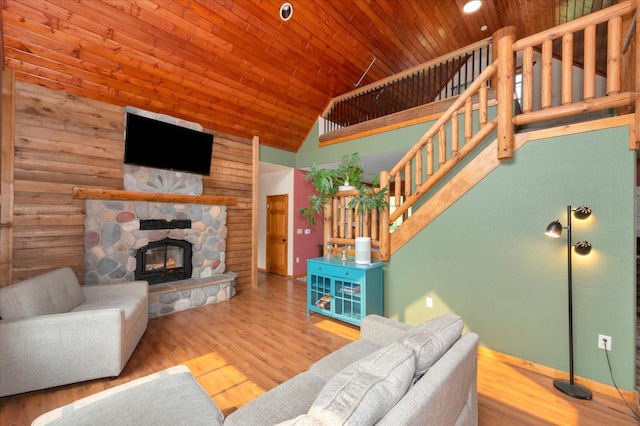 4985 Sam Anderson Rd, Amnicon Twp, WI 54874 - living room with wooden ceiling, high vaulted ceiling, stairway, a fireplace, and wood finished floors