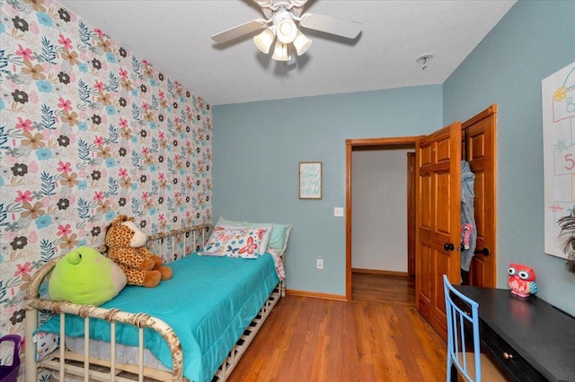 4985 Sam Anderson Rd, Amnicon Twp, WI 54874 - bedroom with light wood-style floors, baseboards, and a ceiling fan