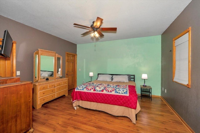 4985 Sam Anderson Rd, Amnicon Twp, WI 54874 - bedroom with wood finished floors and a ceiling fan
