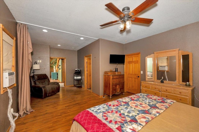 4985 Sam Anderson Rd, Amnicon Twp, WI 54874 - bedroom featuring wood finished floors, recessed lighting, cooling unit, and ceiling fan