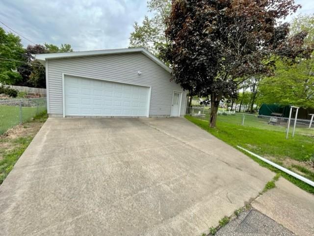 4155 7th St, Goodview, MN 55987 - view of front of house featuring a detached garage and an outbuilding