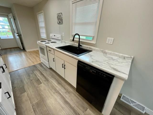 4155 7th St, Goodview, MN 55987 - kitchen featuring electric stove, a sink, dishwasher, white cabinets, and light wood finished floors