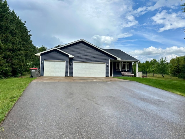 22225 Washington St NE, East Bethel, MN 55011 - ranch-style home featuring asphalt driveway, an attached garage, covered porch, and a front lawn