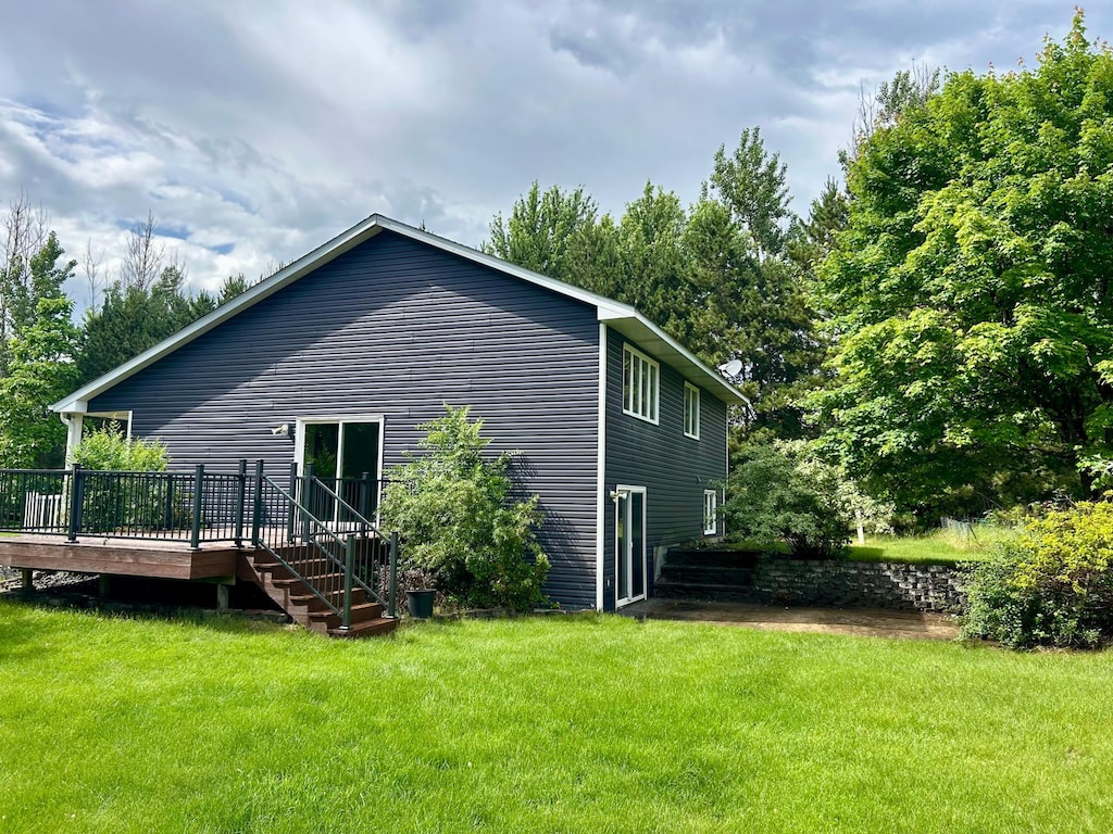 22225 Washington St NE, East Bethel, MN 55011 - view of side of home with a deck, a yard, and stairs