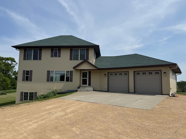 58605 243rd St, Kasota, MN 56050 - view of front facade featuring driveway, an attached garage, and roof with shingles