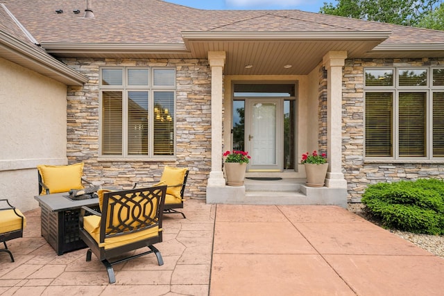 6654 Orchid Ln N, Maple Grove, MN 55311 - view of exterior entry featuring stone siding, roof with shingles, stucco siding, and a patio