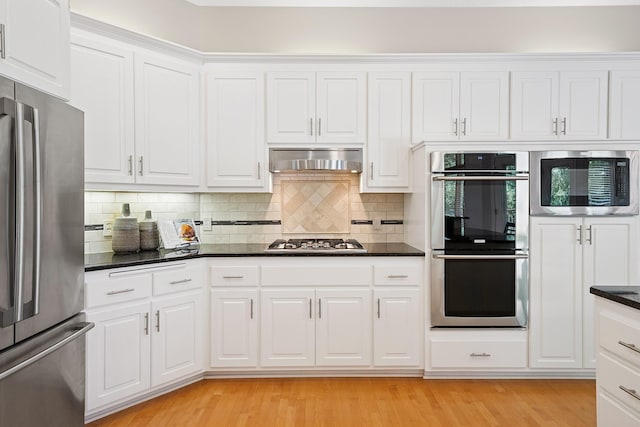 6654 Orchid Ln N, Maple Grove, MN 55311 - kitchen featuring stainless steel appliances, exhaust hood, white cabinetry, and backsplash