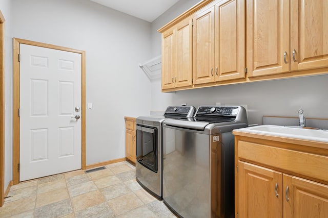 6654 Orchid Ln N, Maple Grove, MN 55311 - laundry room with washing machine and clothes dryer, cabinet space, baseboards, and stone finish floors