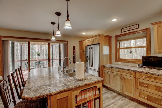 20929 Faron Dr, Nevis, MN 56467 - kitchen with high end refrigerator, a sink, healthy amount of natural light, a center island with sink, and recessed lighting