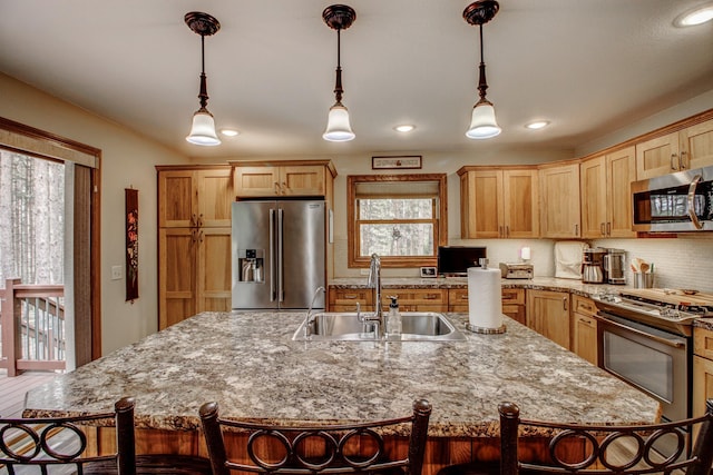 20929 Faron Dr, Nevis, MN 56467 - kitchen with appliances with stainless steel finishes, a sink, healthy amount of natural light, a kitchen island with sink, and recessed lighting