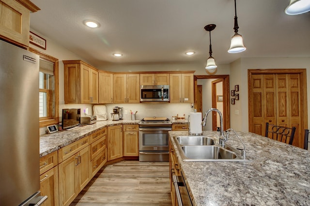 20929 Faron Dr, Nevis, MN 56467 - kitchen with stainless steel appliances, a sink, light wood-style floors, recessed lighting, and hanging light fixtures