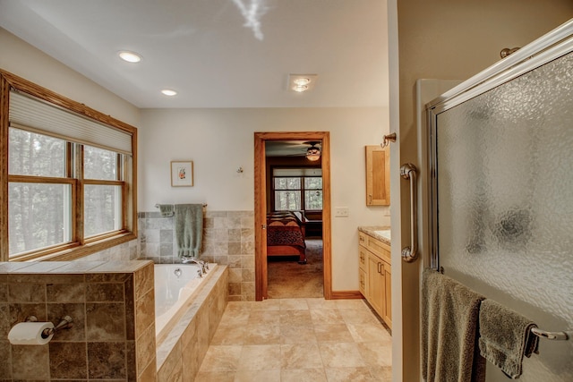 20929 Faron Dr, Nevis, MN 56467 - ensuite bathroom with a stall shower, a garden tub, vanity, a ceiling fan, and tile patterned flooring