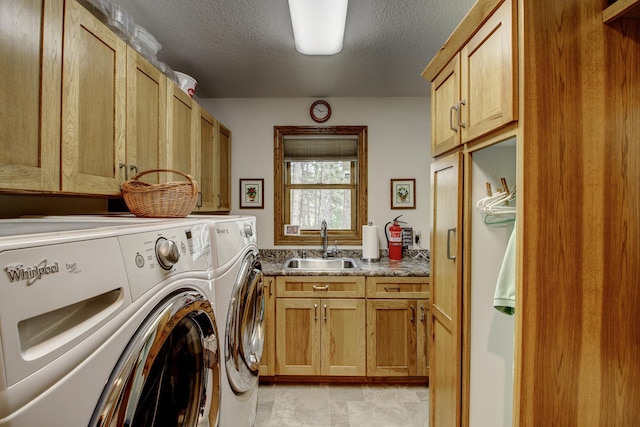 20929 Faron Dr, Nevis, MN 56467 - washroom featuring washing machine and dryer, cabinet space, and a textured ceiling
