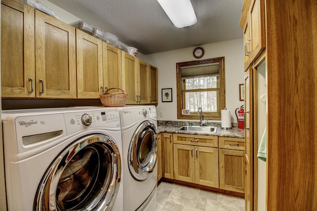 20929 Faron Dr, Nevis, MN 56467 - washroom featuring washer and clothes dryer, cabinet space, and a textured ceiling