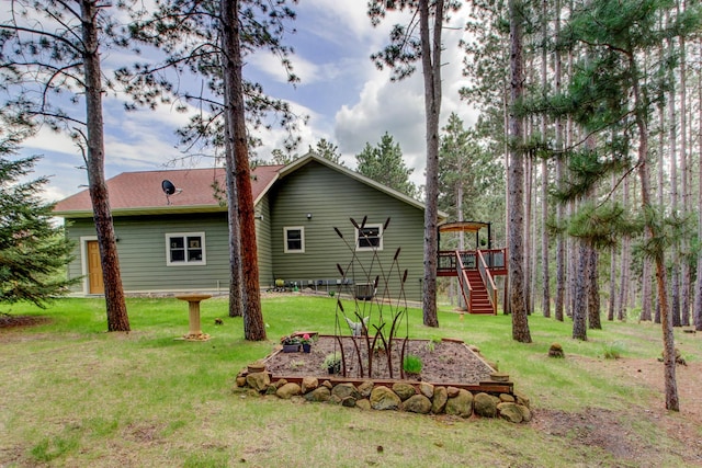 20929 Faron Dr, Nevis, MN 56467 - back of house with stairs, a lawn, and a wooden deck