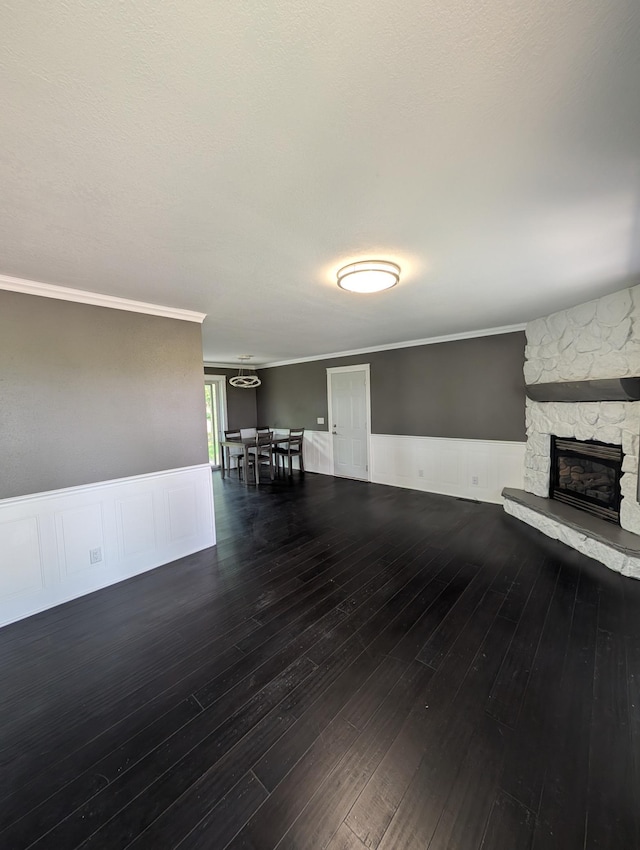 530 Cardinal St, Fairmont, MN 56031 - living room with wainscoting, hardwood / wood-style flooring, a fireplace, and ornamental molding