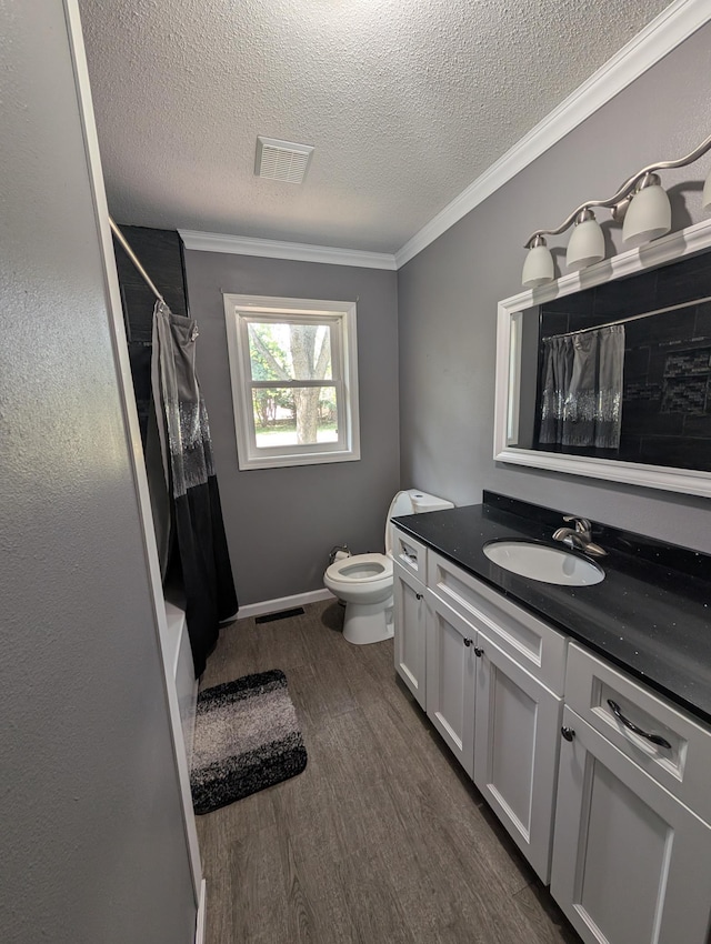530 Cardinal St, Fairmont, MN 56031 - bathroom featuring vanity, crown molding, a textured ceiling, wood finished floors, and toilet
