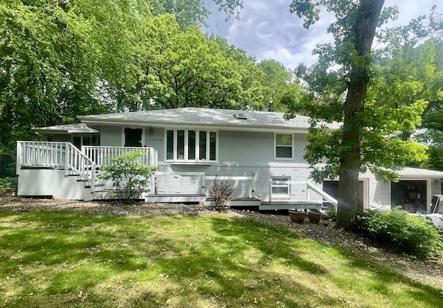 16848 Patricia Ln, Minnetonka, MN 55345 - back of house featuring a deck, a yard, brick siding, and stairs