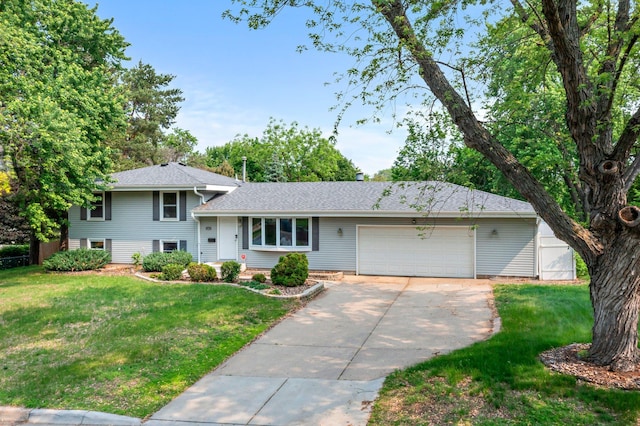 11411 Johnson Cir, Bloomington, MN 55437 - split level home featuring a garage, concrete driveway, and a front lawn