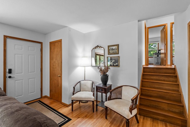 11411 Johnson Cir, Bloomington, MN 55437 - living area featuring light wood-type flooring, baseboards, and stairway