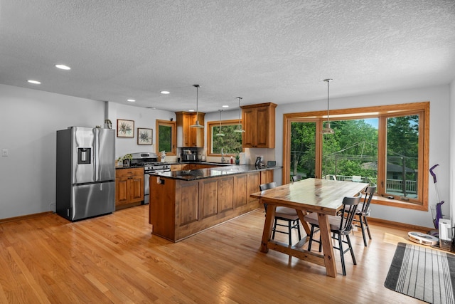 11411 Johnson Cir, Bloomington, MN 55437 - kitchen featuring stainless steel appliances, brown cabinets, a sink, a textured ceiling, and recessed lighting