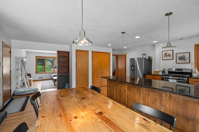 11411 Johnson Cir, Bloomington, MN 55437 - dining room with a textured ceiling, light wood finished floors, and recessed lighting