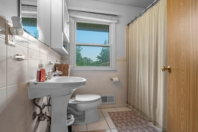 11411 Johnson Cir, Bloomington, MN 55437 - bathroom with tile walls, tile patterned flooring, toilet, a shower with shower curtain, and wainscoting